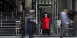 A waiter at the Lloyd's building entrance